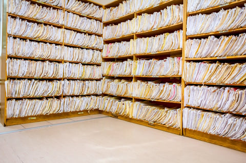 Shelves are full with folders and files of medical record, patient information