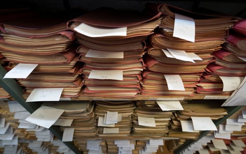 Stacks of old papers and files in an archive