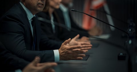 Close up on hands of organization representative speaking at conference